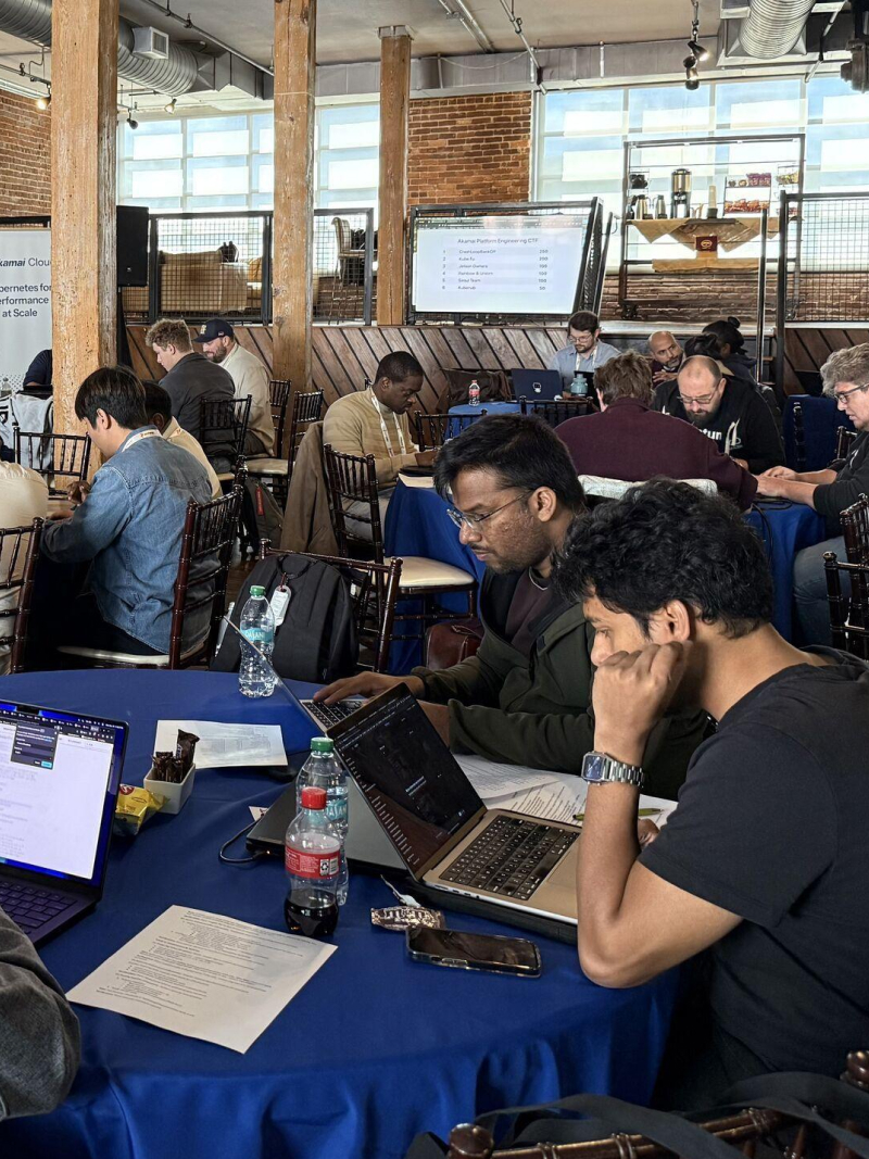 A host leading an audience quiz at a previous Kubernetes event